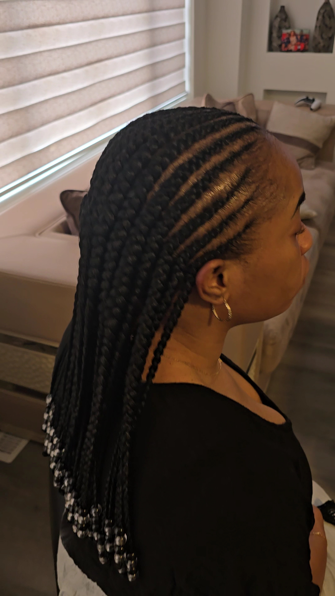 Feed-in braids with beaded ends styled at Fingertips Hair Salon
